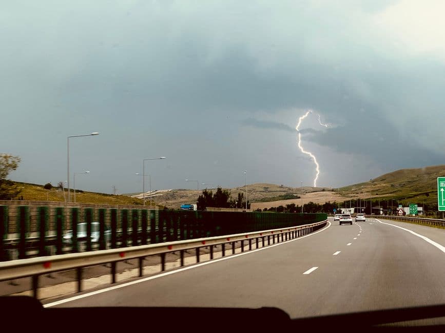 Dramatic lightning storm over a Central PA highway, viewed from inside a vehicle.