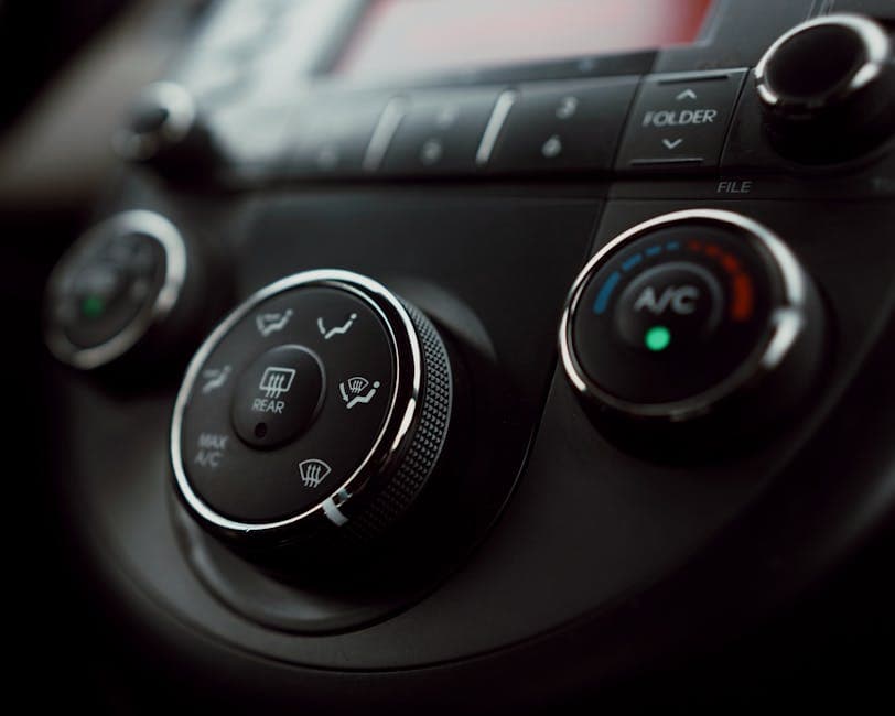 Detailed close-up of car dashboard air conditioning controls for a car AC blowing warm air in a Pennsylvania summer.