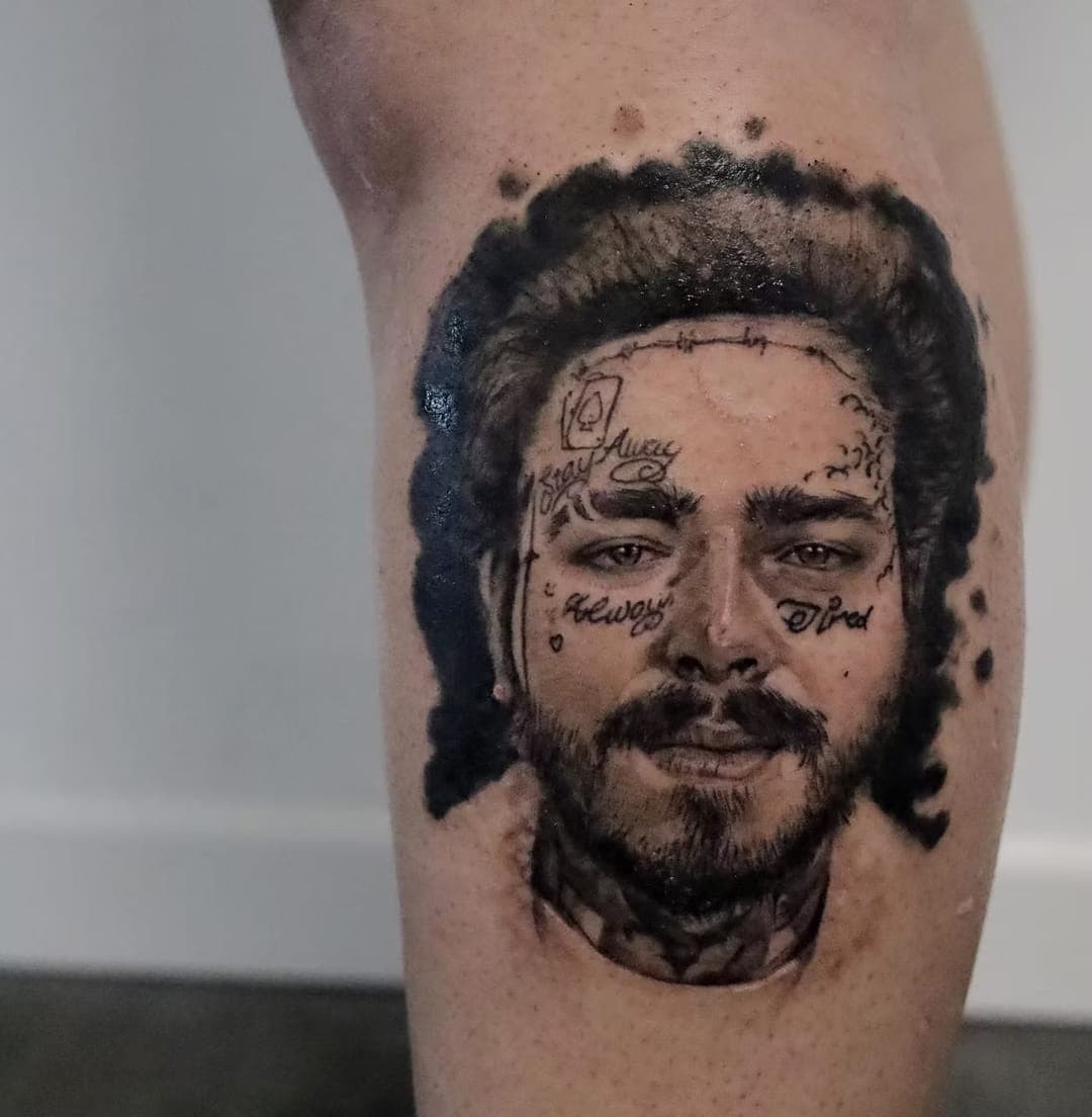Black-and-grey realism portrait tattoo of a bearded man with face tattoos, on a calf, by 5 Pound Gummy Tattoo Collective