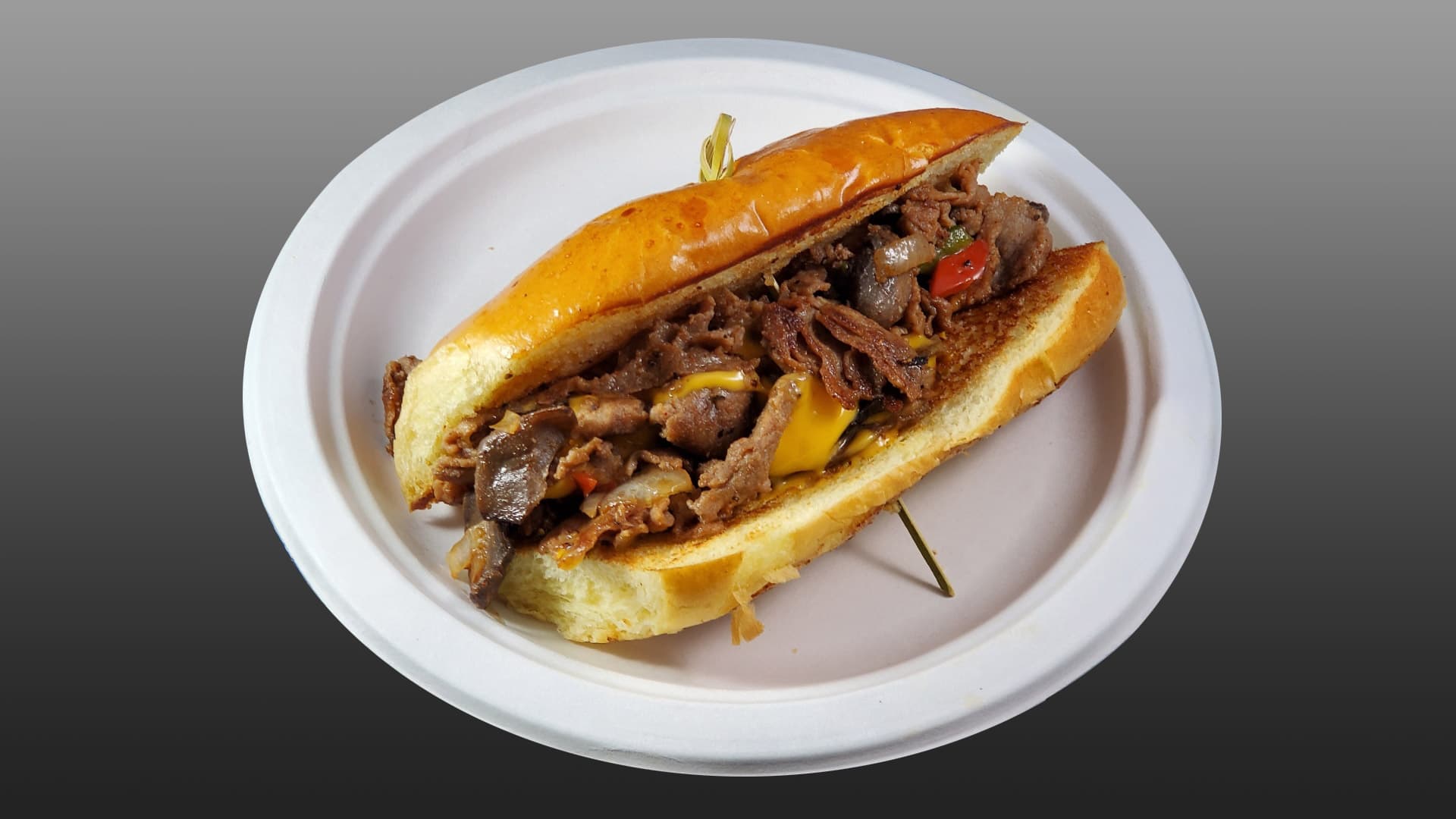 Philly cheesesteak with grilled steak, peppers, onions, and cheese on a toasted roll at Cheezie Sam's Grill
