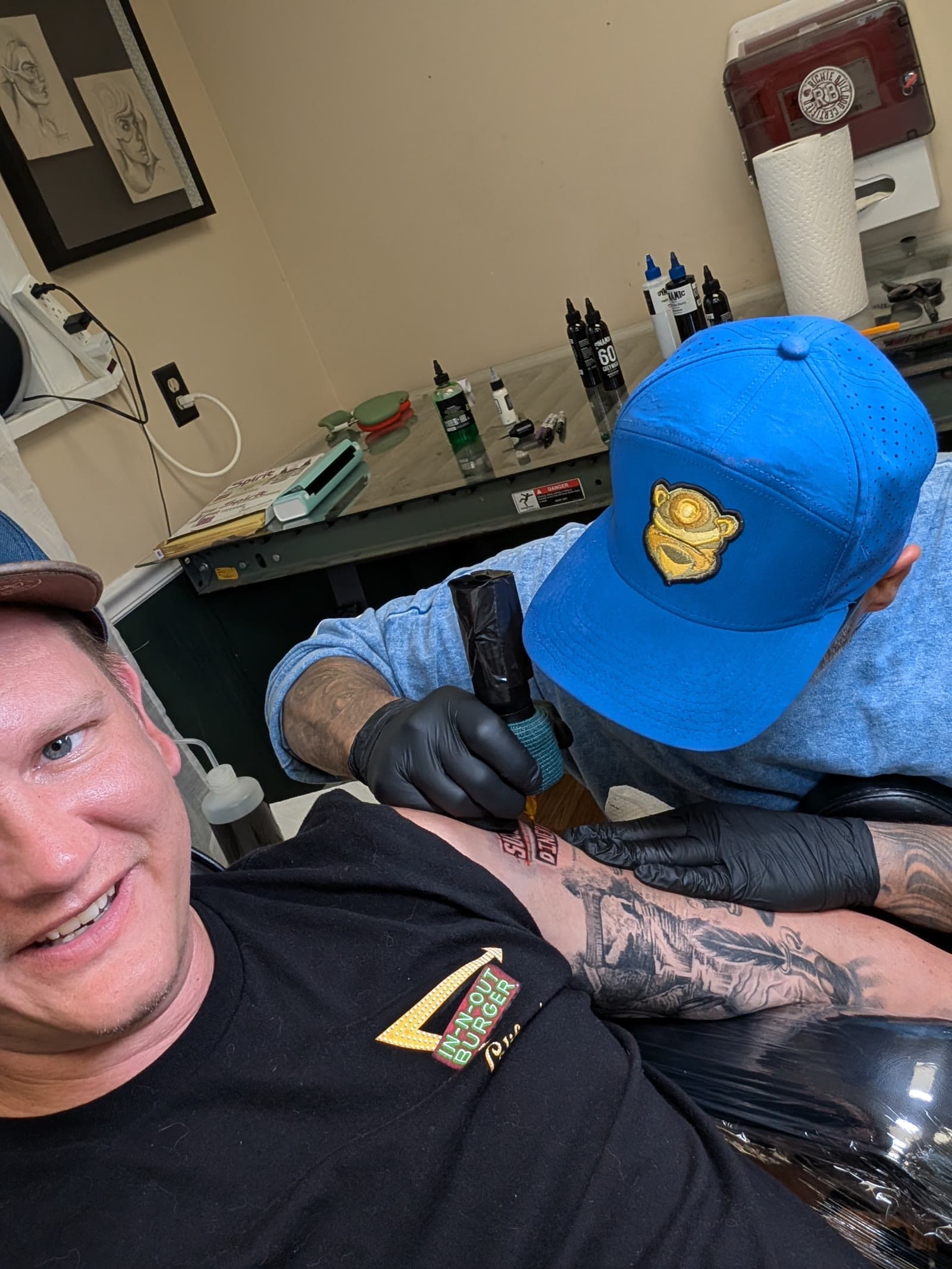 NextGen AutoWorks owner Brandon Large in the chair at 5 Pound Gummy Tattoo Collective in Hershey while an artist tattoos his arm