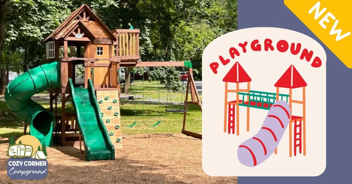 Cozy Corner Campground's new wooden playground in Jonestown, PA — a timber play set with a green tube slide, a climbing wall, and swings under shade trees